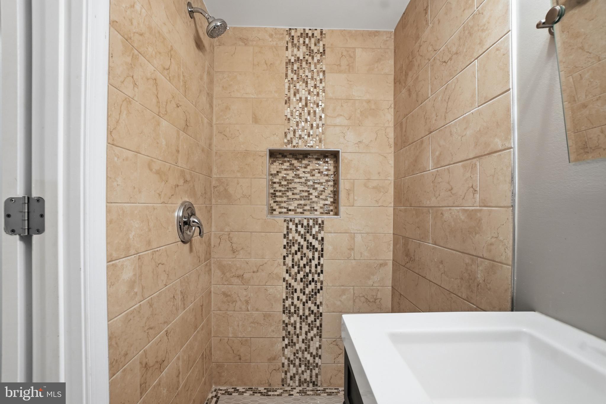 1118 Chicago Street Southeast Washington, DC 20020 - Photo 11 of 27 Elegant tiled shower with modern accents.