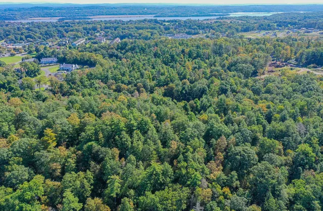 an aerial view of a city with lots of residential buildings and mountain view