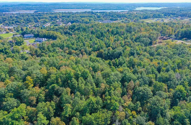 an aerial view of a city with lots of residential buildings and mountain view