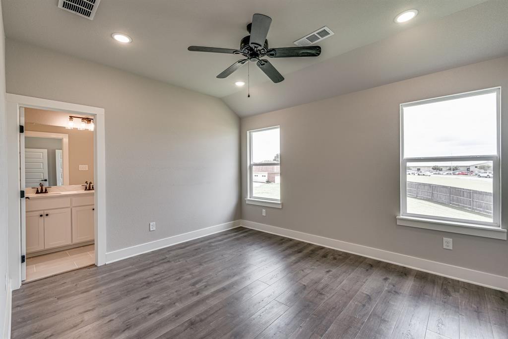 912 Cooksey Court, Unit A Grandview, TX 76050 - Photo 14 of 30 a view of an empty room and window and wooden floor