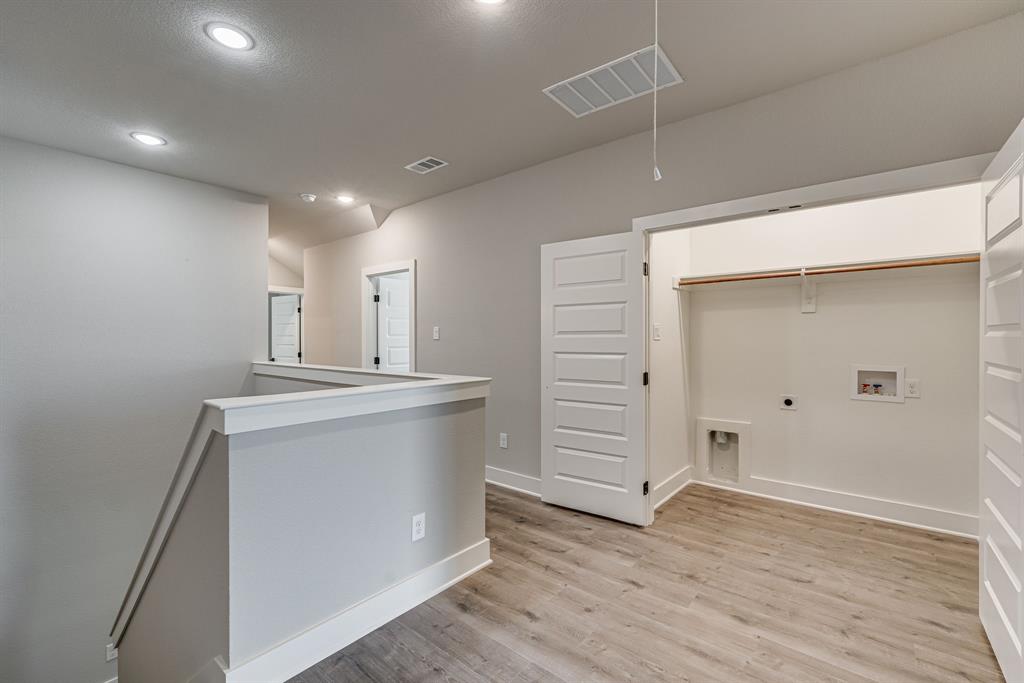 912 Cooksey Court, Unit A Grandview, TX 76050 - Photo 21 of 30 an empty room with wooden floor and cabinet