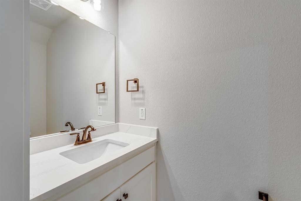 912 Cooksey Court, Unit A Grandview, TX 76050 - Photo 22 of 30 a bathroom with a sink and a mirror