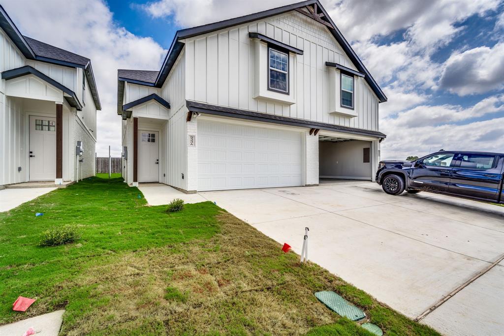 912 Cooksey Court, Unit A Grandview, TX 76050 - Photo 7 of 30 a front view of a house with garden