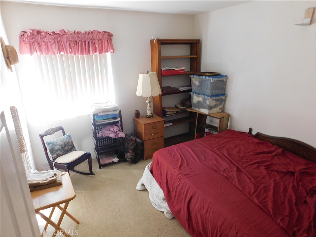 2368 Bayberry Way Hemet, CA 92545 - Photo 4 of 13 a bedroom with a bed and a chair