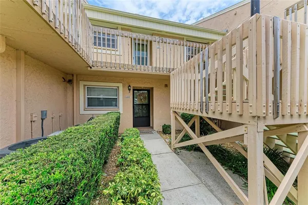 a view of a house with backyard and porch