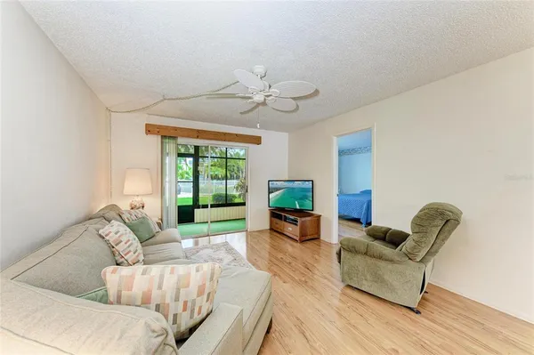 a living room with furniture and a chandelier