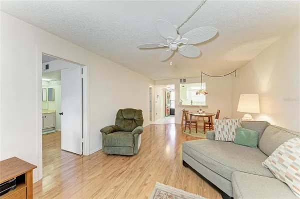 a living room with a bed furniture and a window