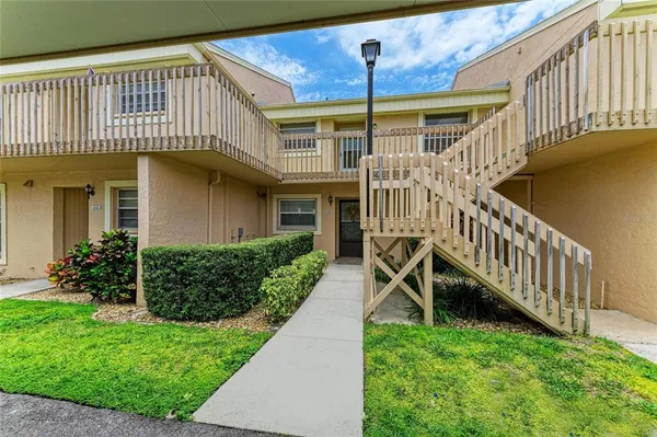 a view of a house with backyard and porch
