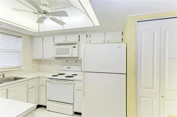 a white refrigerator freezer sitting inside of a kitchen