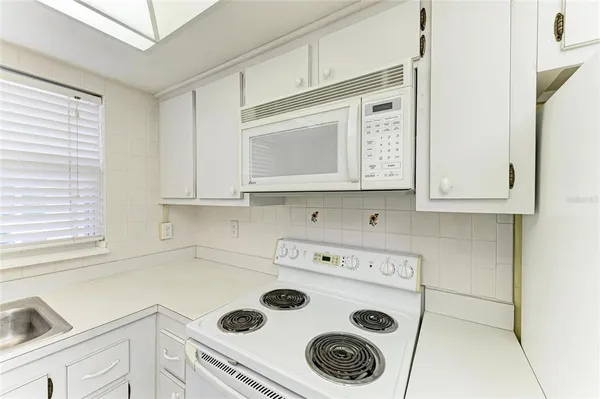 a kitchen with a stove and a microwave