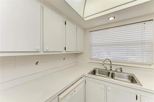 a kitchen with white cabinets and a sink