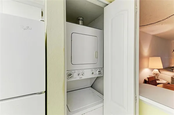 a kitchen with a refrigerator a stove a sink dishwasher and a refrigerator with wooden floor