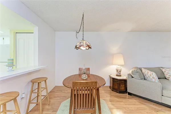 a living room with furniture chandelier and a window