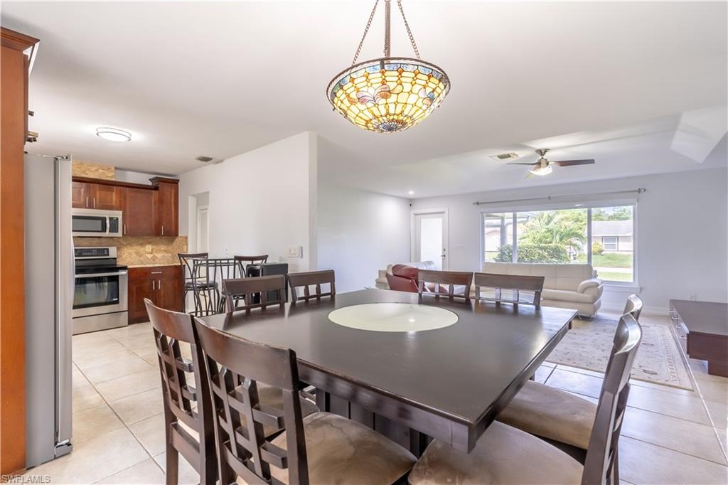 2100 55th Street Southwest Naples, FL 34116 - Photo 26 of 50 a view of a dining room with furniture window and outside view