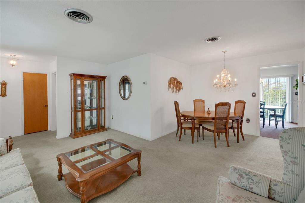 2214 Topping Place Eustis, FL 32726 - Photo 11 of 57 a living room with furniture and a chandelier