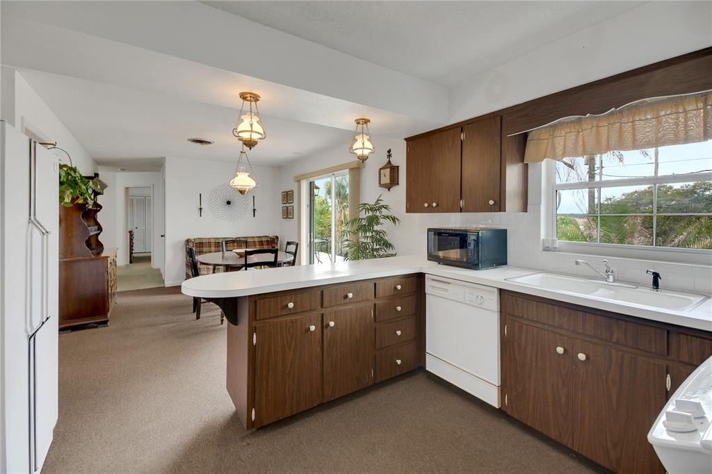 2214 Topping Place Eustis, FL 32726 - Photo 21 of 57 a kitchen with a sink cabinets and window