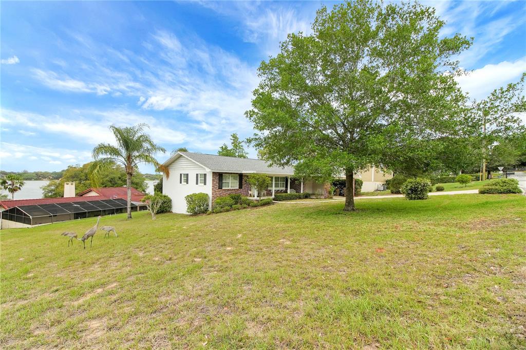 2214 Topping Place Eustis, FL 32726 - Photo 45 of 57 a view of a house with a yard and sitting area