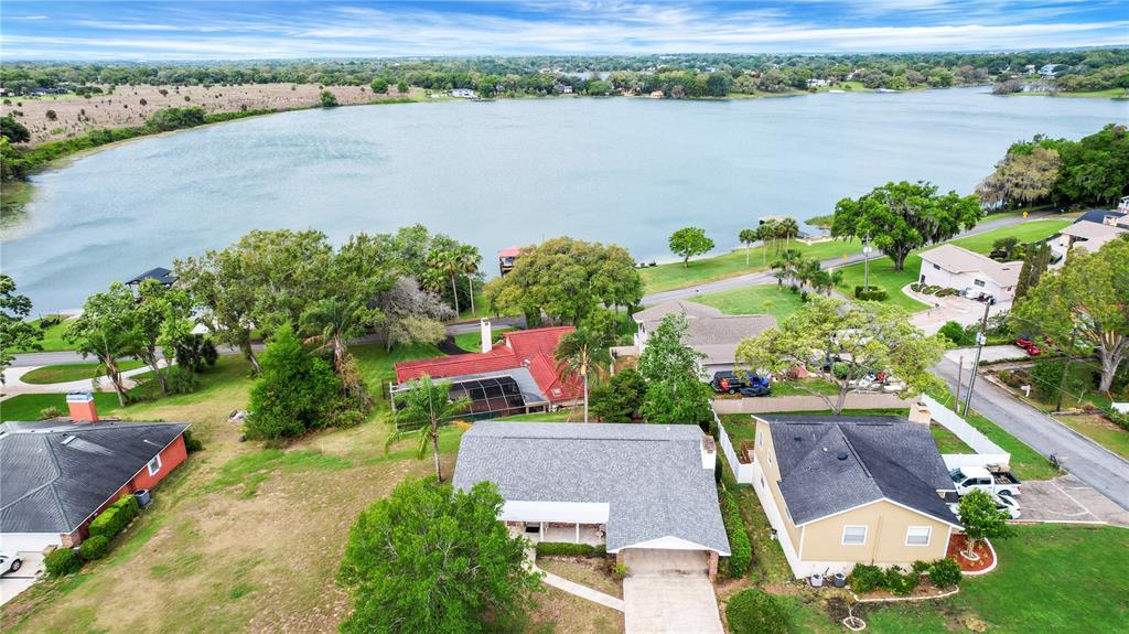 2214 Topping Place Eustis, FL 32726 - Photo 48 of 57 an aerial view of a house with a lake view
