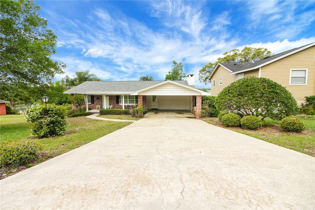 2214 Topping Place Eustis, FL 32726 - Photo 50 of 57 a front view of a house with a yard