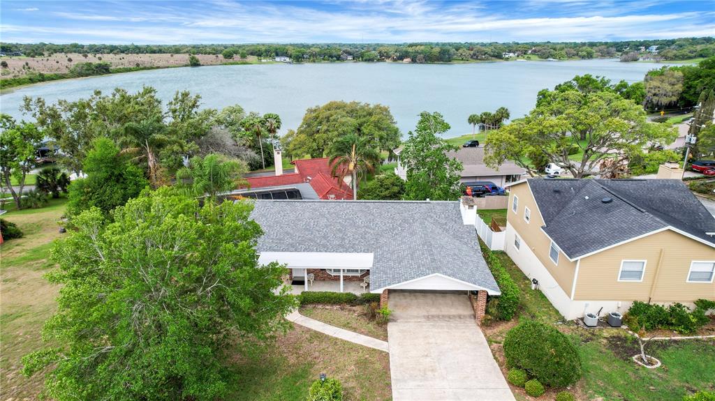 2214 Topping Place Eustis, FL 32726 - Photo 54 of 57 an aerial view of a house with a lake view