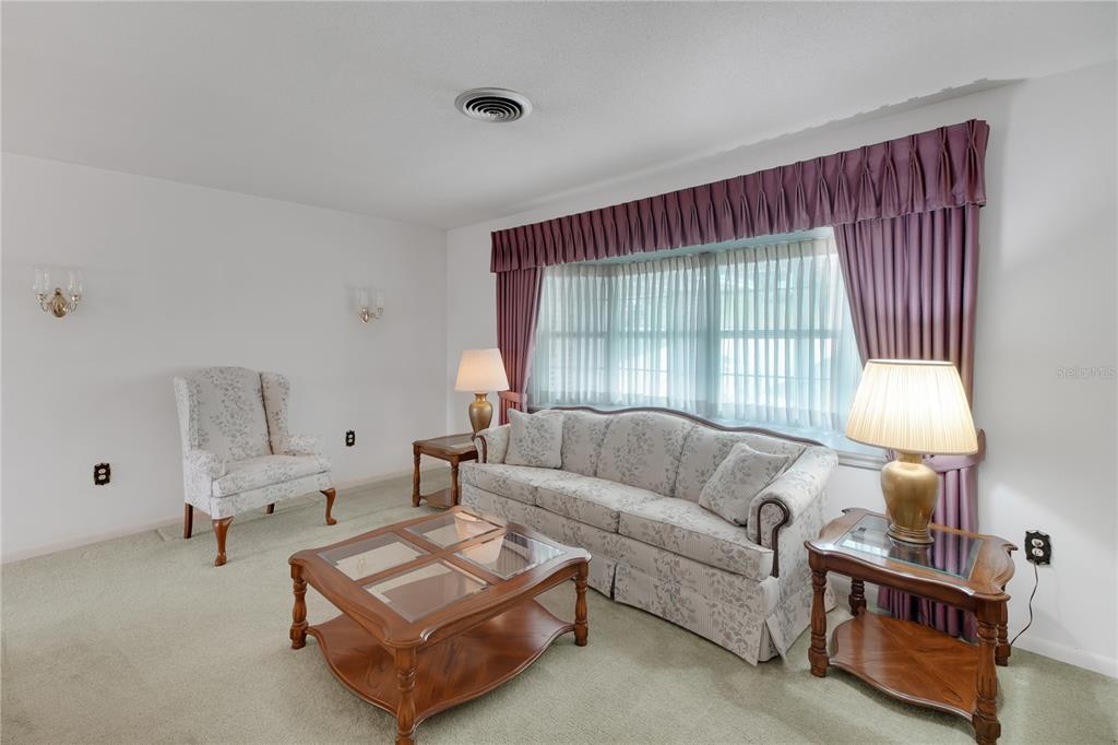 2214 Topping Place Eustis, FL 32726 - Photo 8 of 57 a living room with furniture and a window