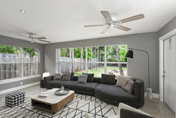 a living room with furniture and a large window