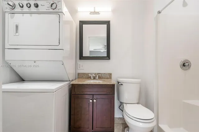 an empty room with windows and ceiling fan