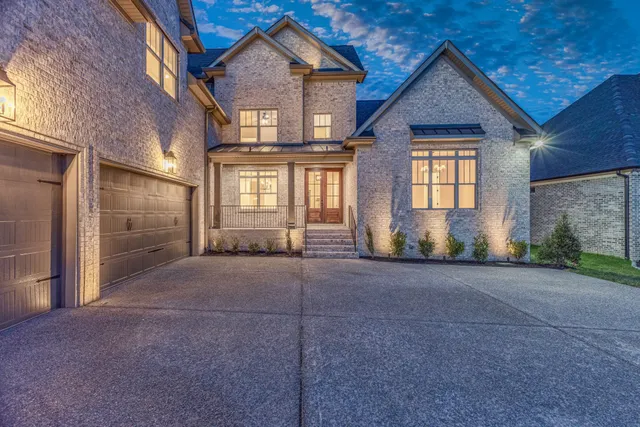 a view of a house with a yard and garage