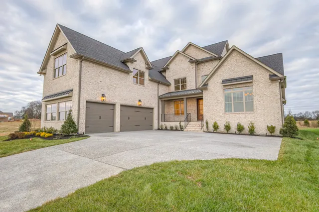 a kitchen with a sink stainless steel appliances and white cabinets