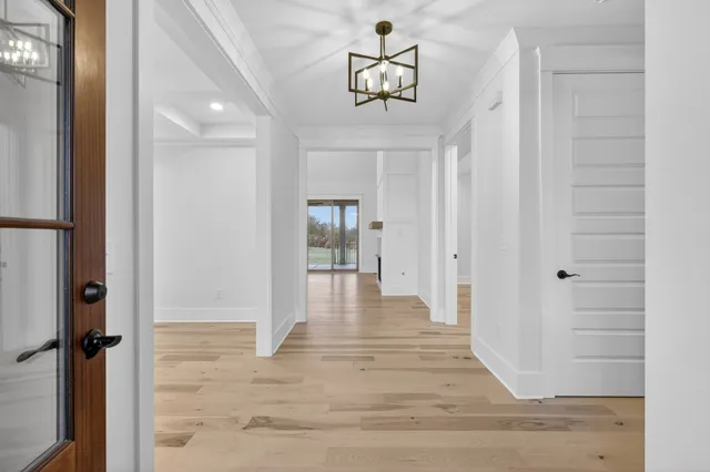 a large kitchen with stainless steel appliances granite countertop a lot of counter space and wooden floor