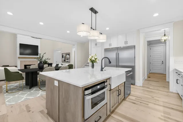 a living room with furniture and a view of kitchen