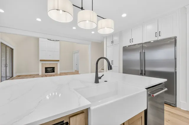 a large kitchen with stainless steel appliances granite countertop a sink stove and refrigerator