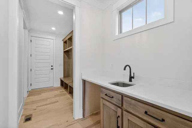 a bedroom with a bed window and a flat screen tv