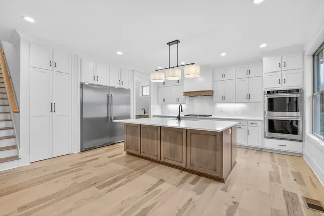 a view of a room with wooden floor and a sink
