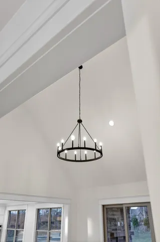 an empty room with closet and a chandelier fan