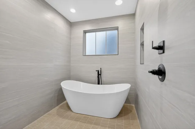 a front view of a house with a garden and yard