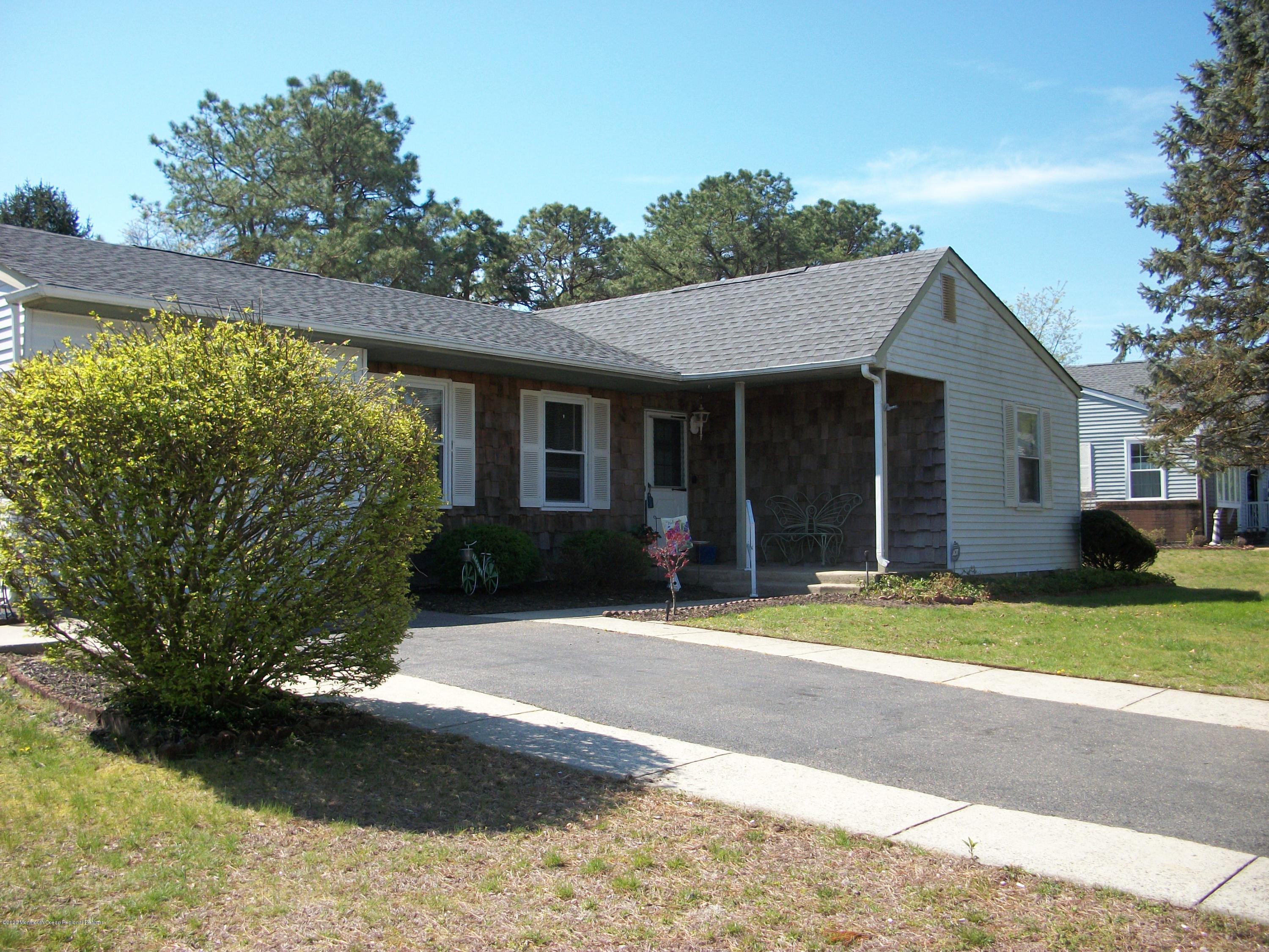 4 Alpine Road Whiting, NJ 08759 - Photo 1 of 37 a front view of a house with a yard and garage