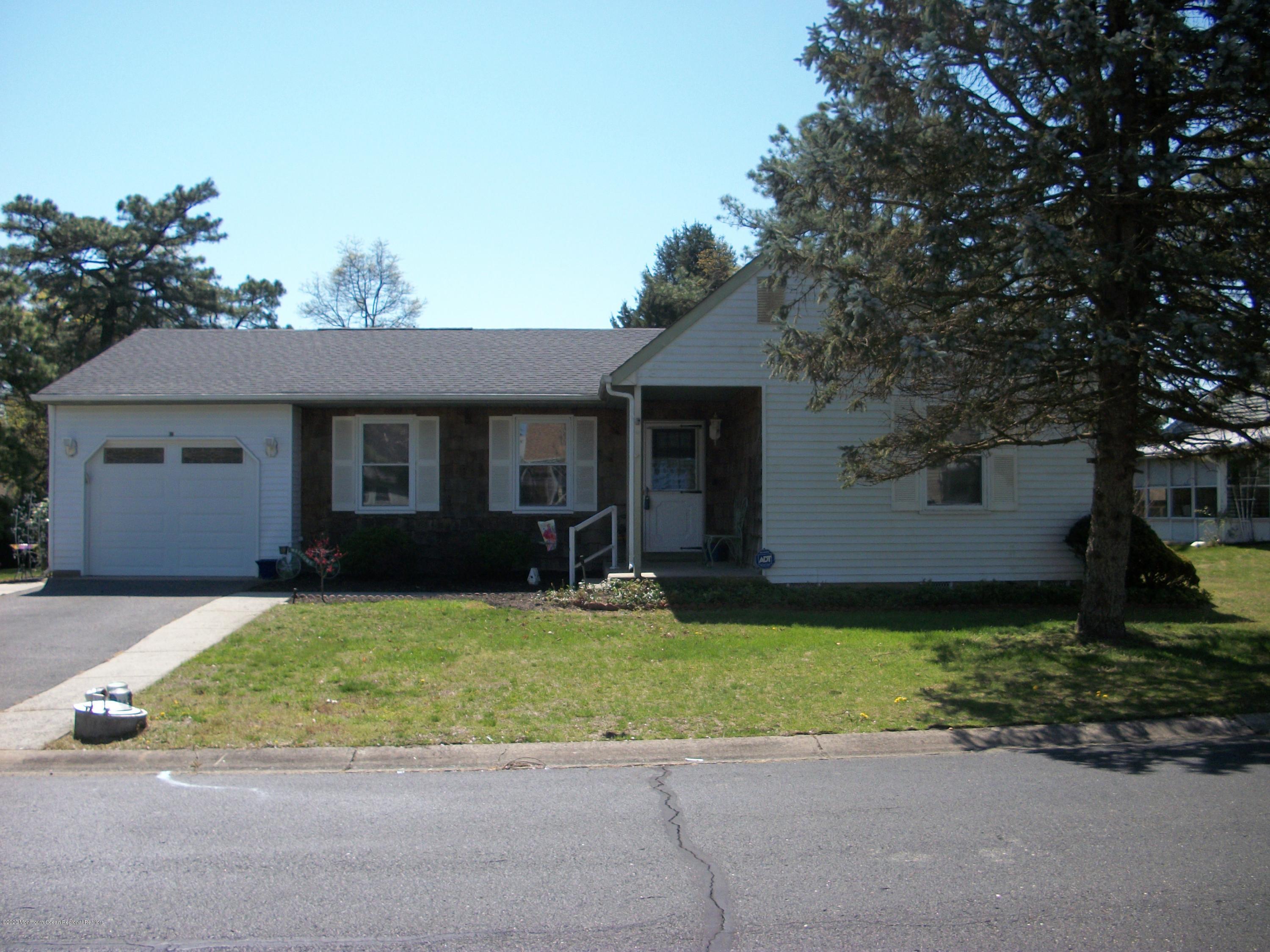 4 Alpine Road Whiting, NJ 08759 - Photo 2 of 37 a front view of a house with a yard and garage