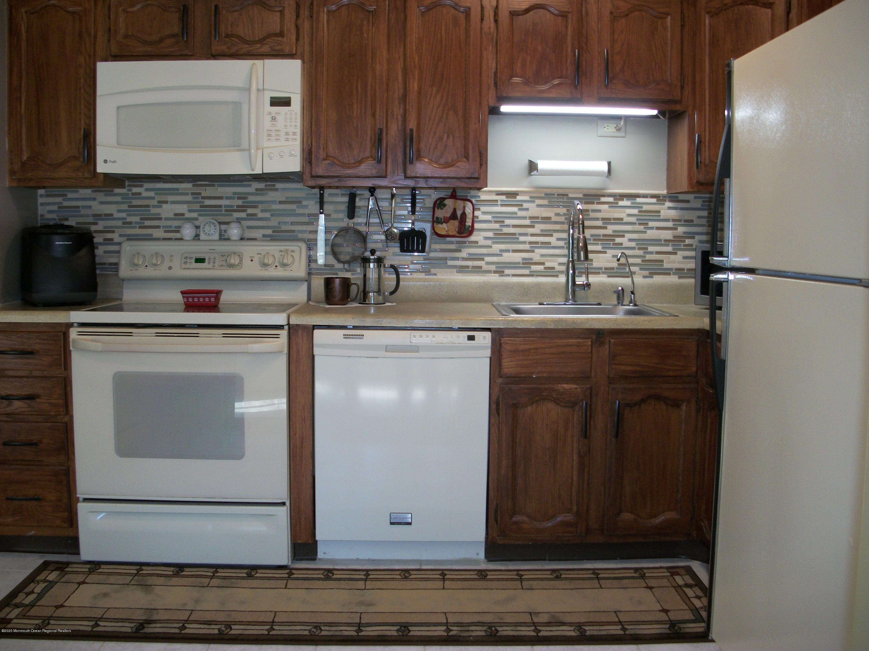 4 Alpine Road Whiting, NJ 08759 - Photo 11 of 37 a kitchen with stainless steel appliances granite countertop a sink stove and cabinets