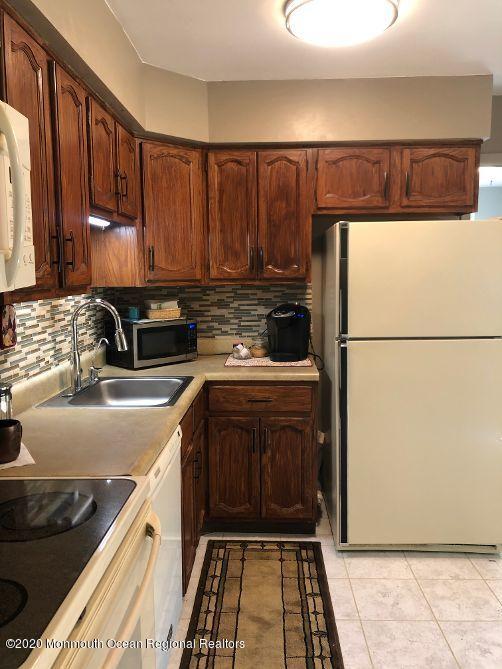 4 Alpine Road Whiting, NJ 08759 - Photo 12 of 37 a kitchen with a sink a stove and a refrigerator