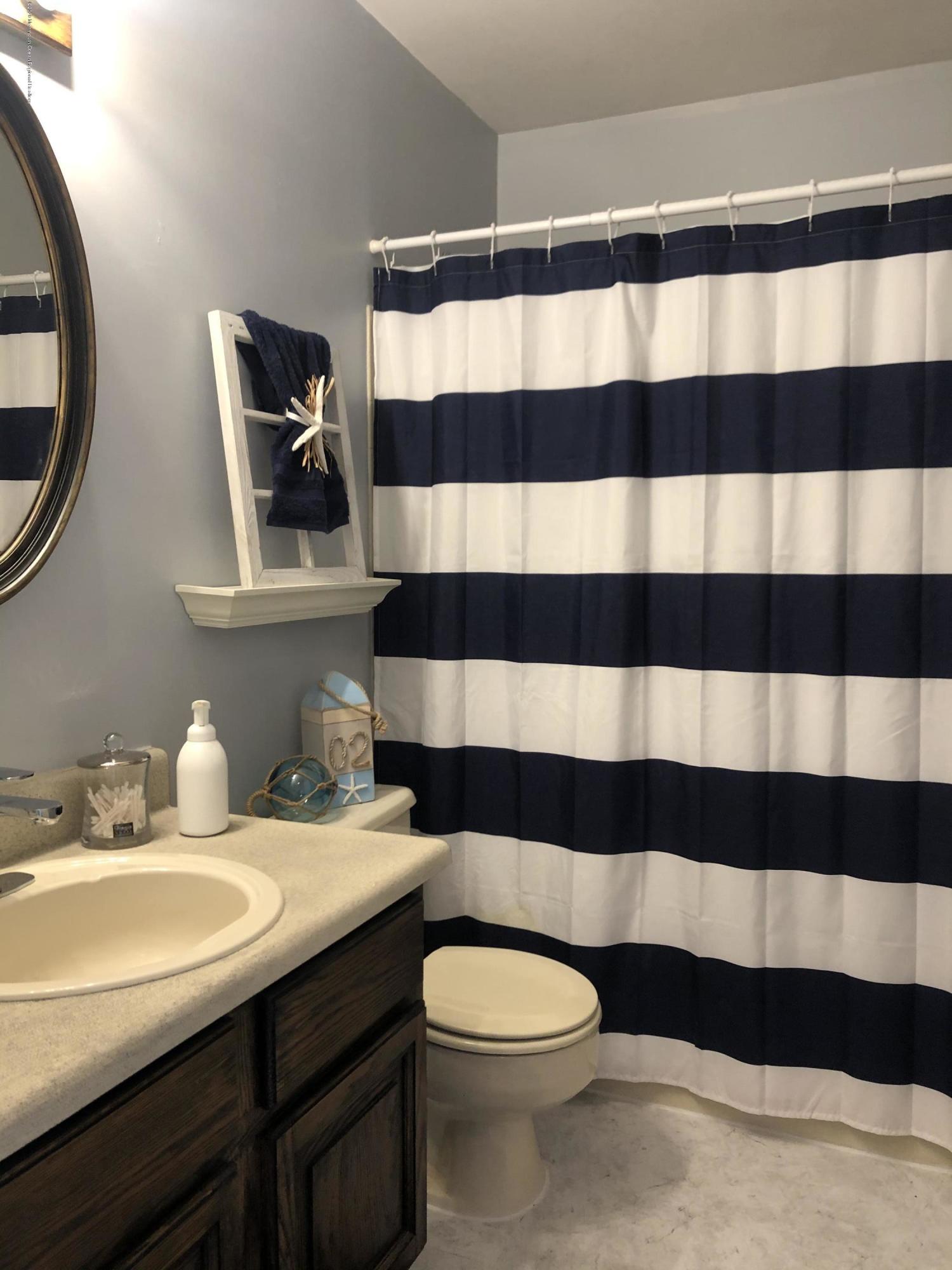 4 Alpine Road Whiting, NJ 08759 - Photo 15 of 37 a bathroom with a sink a toilet and a mirror