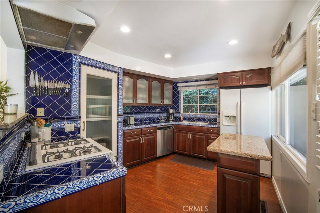 33915 Robles Drive, Unit A Dana Point, CA 92629 - Photo 11 of 37 a kitchen with kitchen island granite countertop a stove and a refrigerator