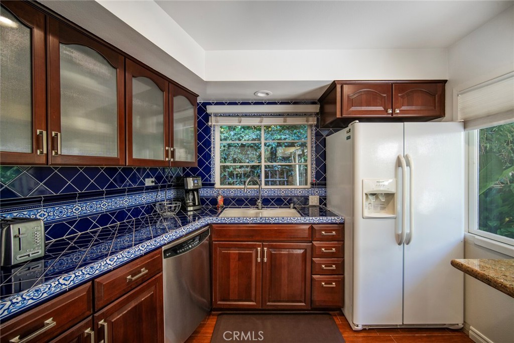 33915 Robles Drive, Unit A Dana Point, CA 92629 - Photo 12 of 37 a kitchen with stainless steel appliances granite countertop a refrigerator and a stove