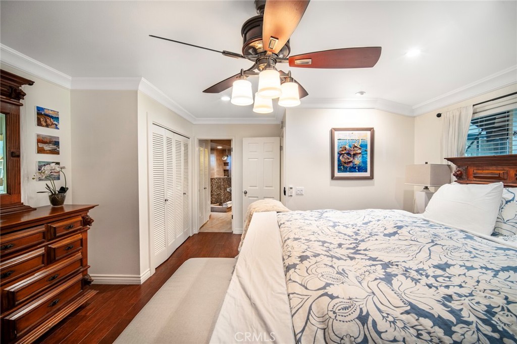 33915 Robles Drive, Unit A Dana Point, CA 92629 - Photo 15 of 37 a bedroom with a bed and a chandelier