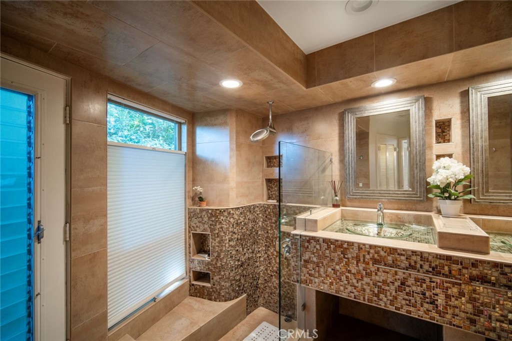 33915 Robles Drive, Unit A Dana Point, CA 92629 - Photo 17 of 37 a bathroom with a granite countertop sink and a mirror