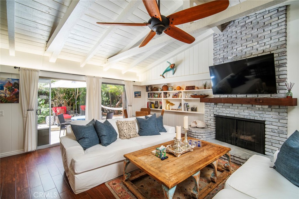33915 Robles Drive, Unit A Dana Point, CA 92629 - Photo 5 of 37 a living room with furniture a flat screen tv and a fireplace