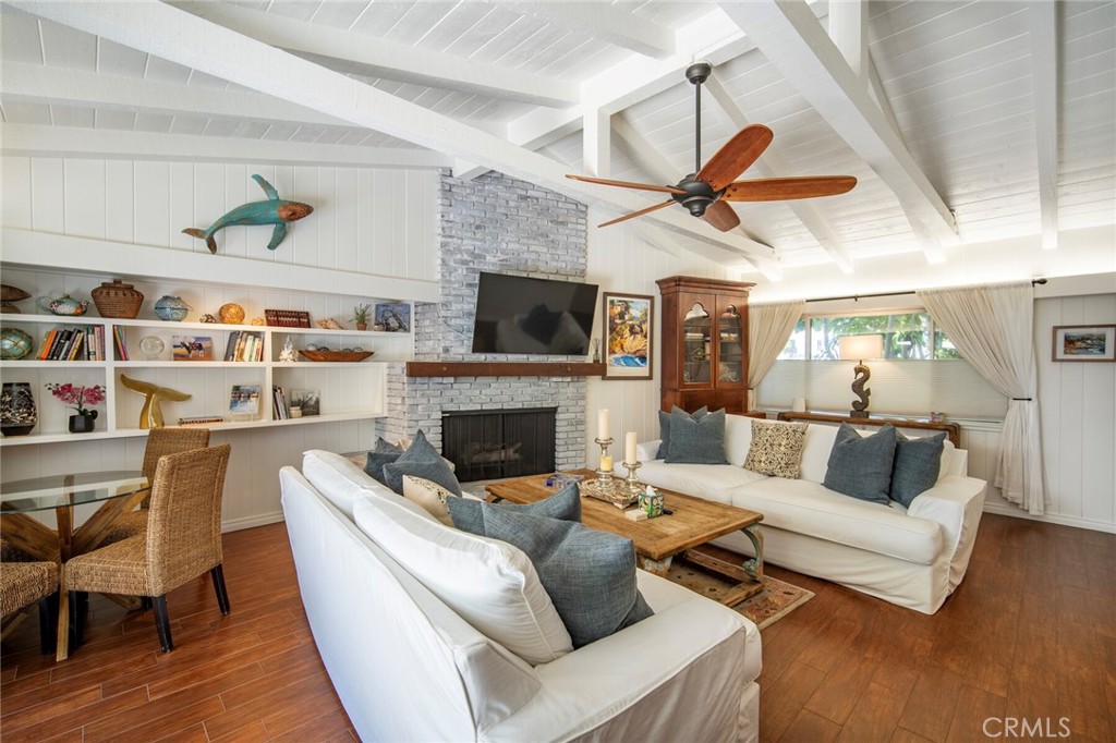 33915 Robles Drive, Unit A Dana Point, CA 92629 - Photo 7 of 37 a living room with furniture fireplace and a flat screen tv