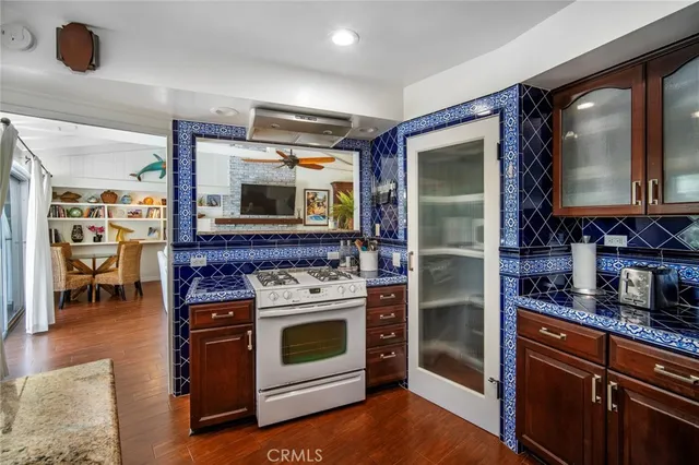 a kitchen with stainless steel appliances granite countertop a stove and a microwave