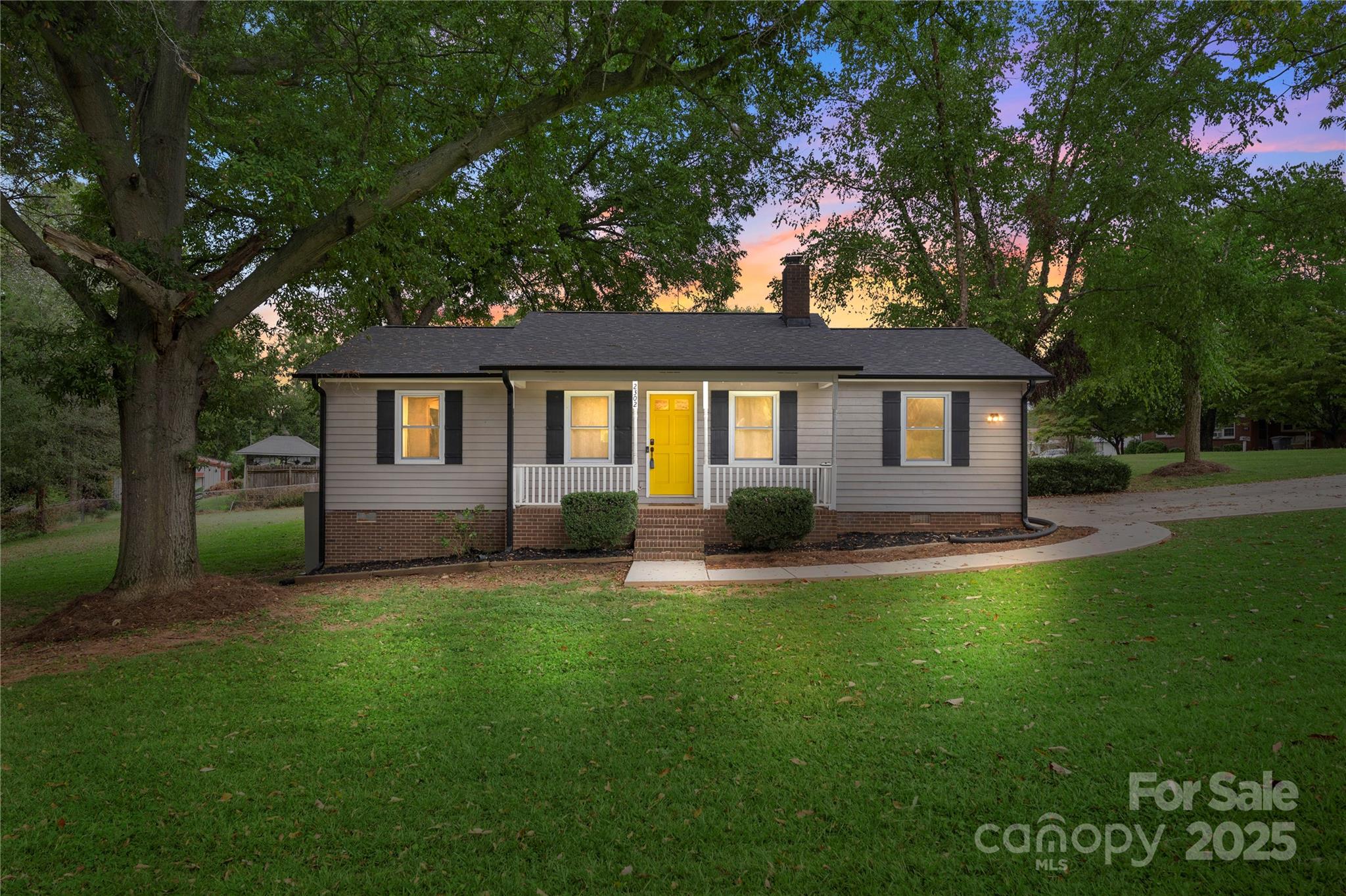 2302 Old Hickory Grove Road Mount Holly, NC 28120 - Photo 1 of 48 a backyard of a house with table and chairs
