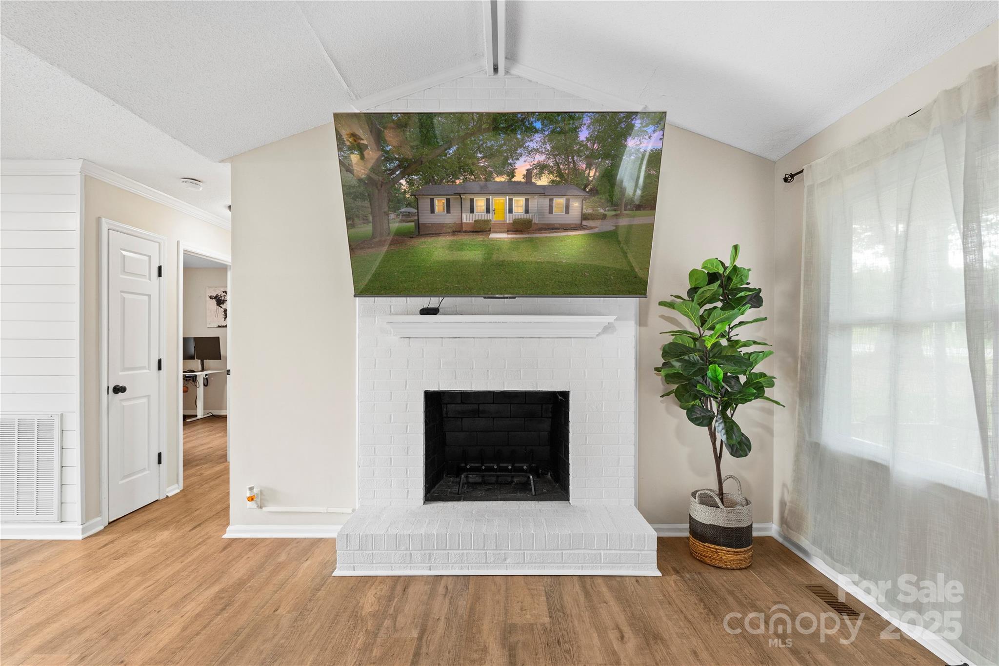 2302 Old Hickory Grove Road Mount Holly, NC 28120 - Photo 14 of 48 a living room with a fireplace and a potted plant